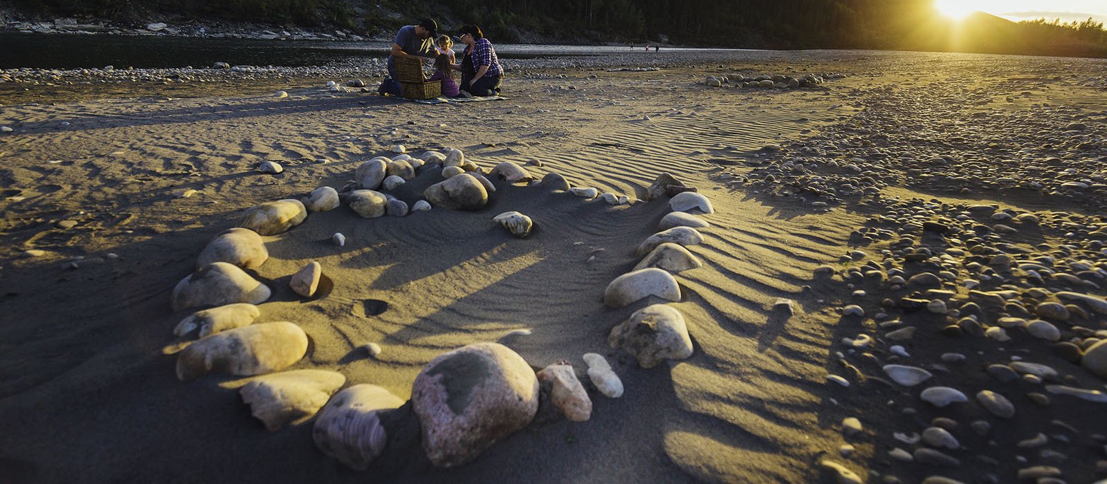 Family picnicking on beach at Pipestone Creek
